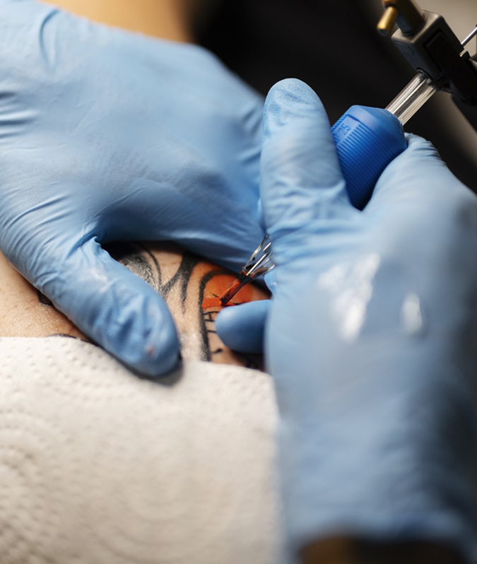 Tattoo artist working